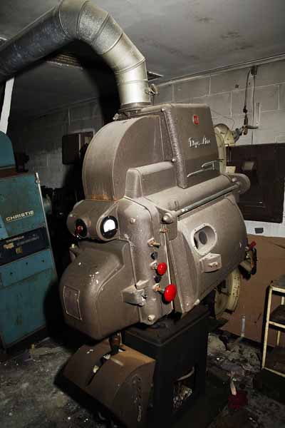 I would give my eye-teeth to fire that baby up.  For those who are interested, that is an RCA Dyna-Arc 35mm movie projector.  The arc is for carbon arc, a very hot and brillint light soucre used to project the film.  Notice that it actualy has to be vented like a cloths dryer.
